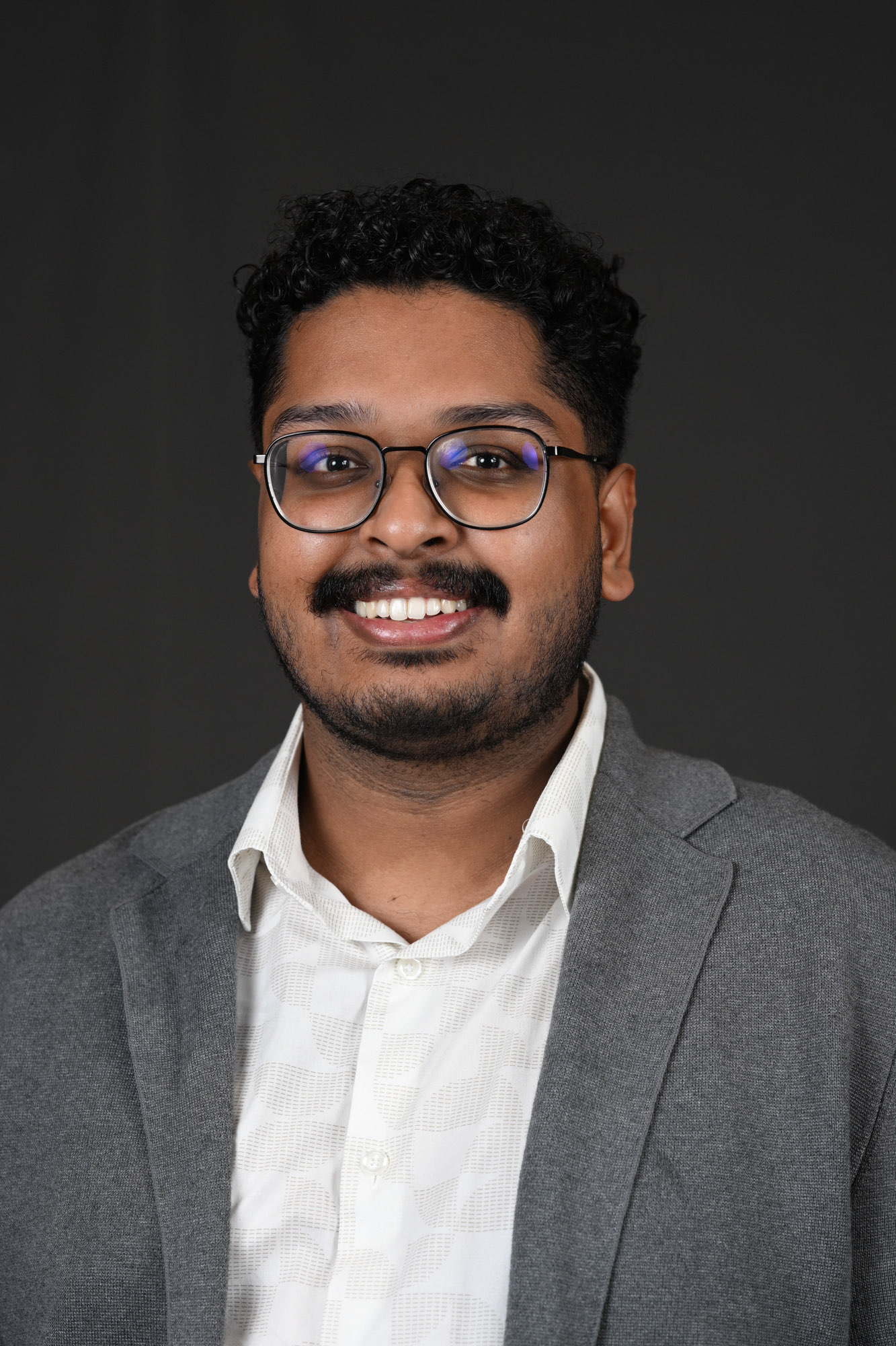 Kaushik Ram in a gray blazer