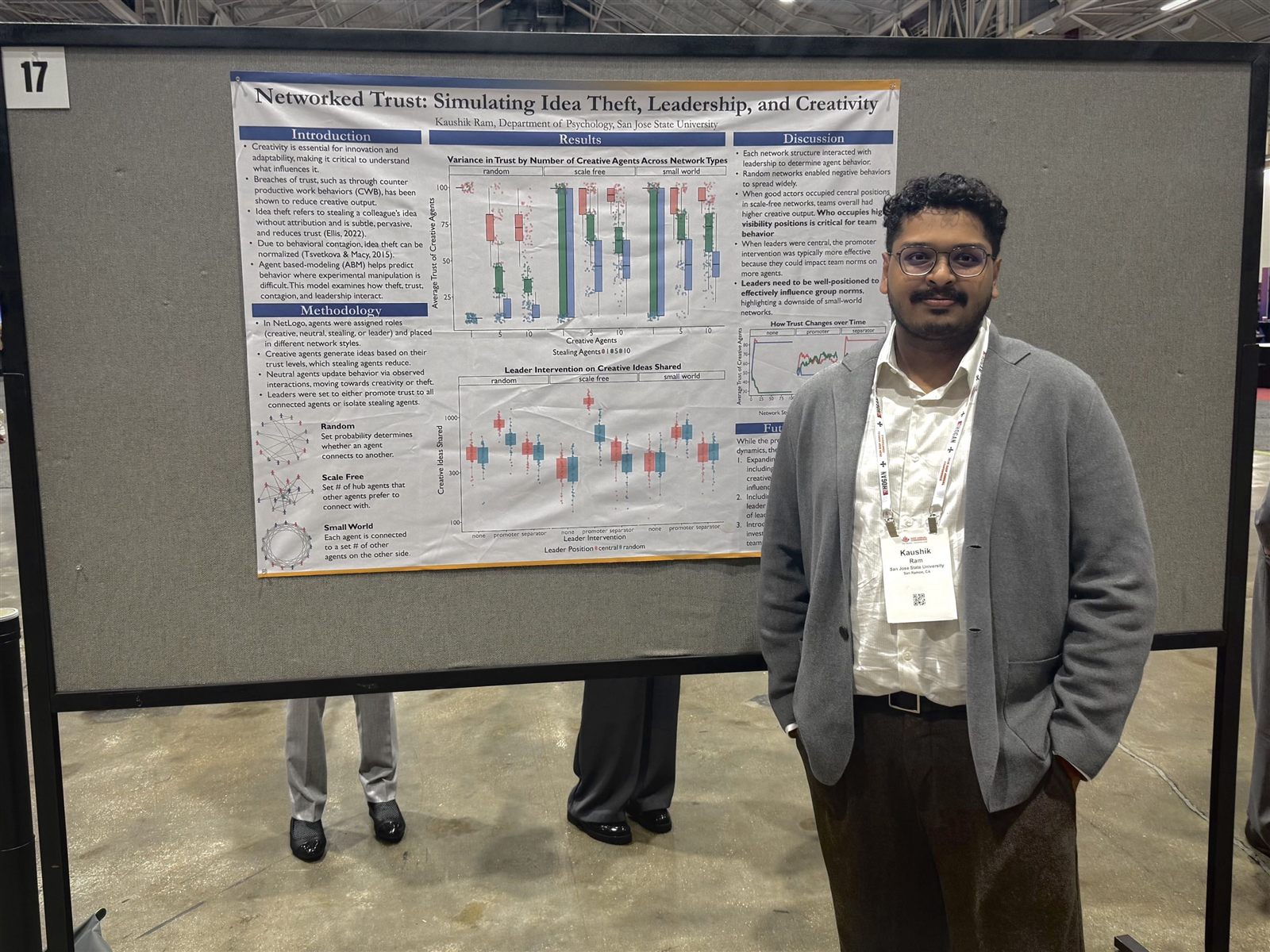 Kaushik Ram standing beside his Networked Trust research poster